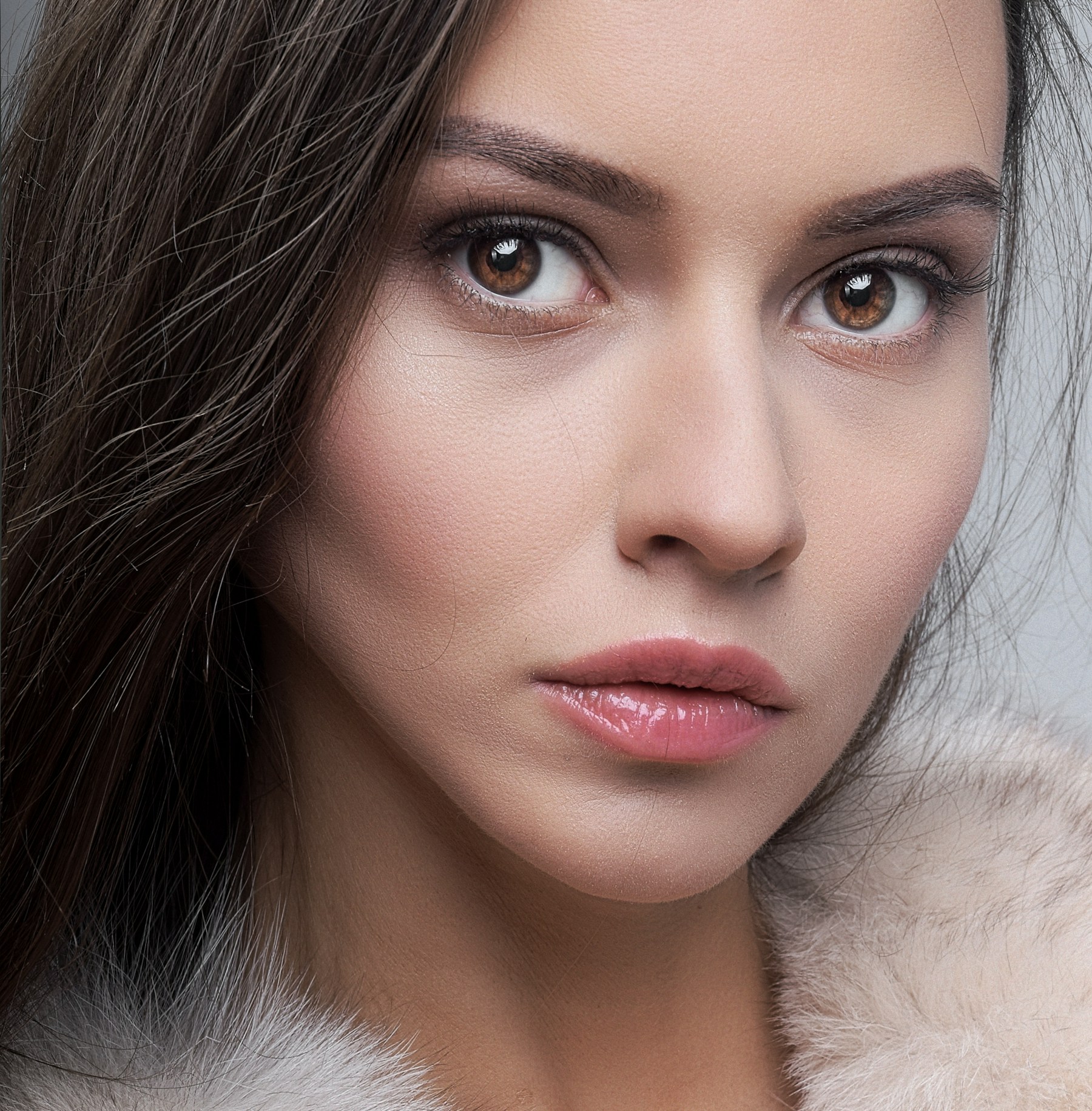 a woman wearing a fur collar and a fur coat